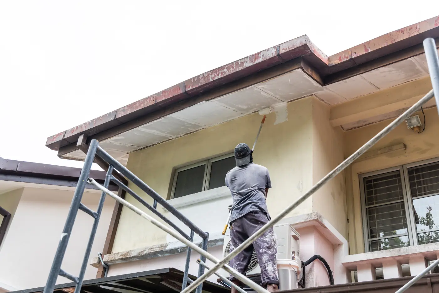 Painter worker adding undercoat foundation paint